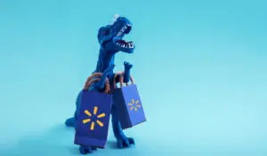 a toy dinosaur holding shopping bags