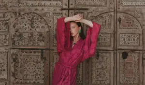 a woman in a pink robe posing for a picture