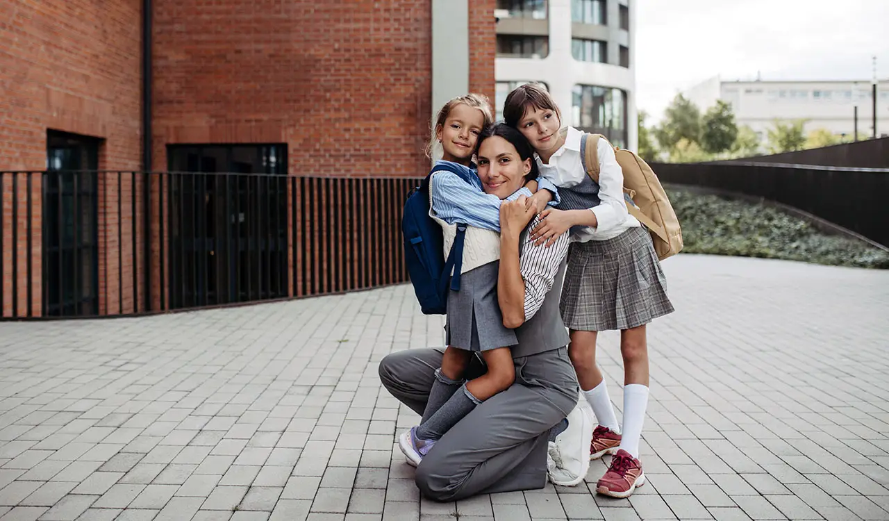 a woman hugging two children