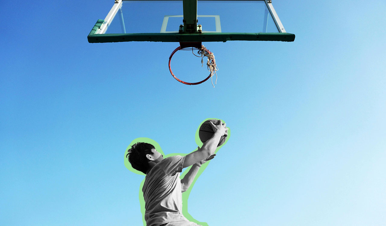 guy jumping up to basketball hoop