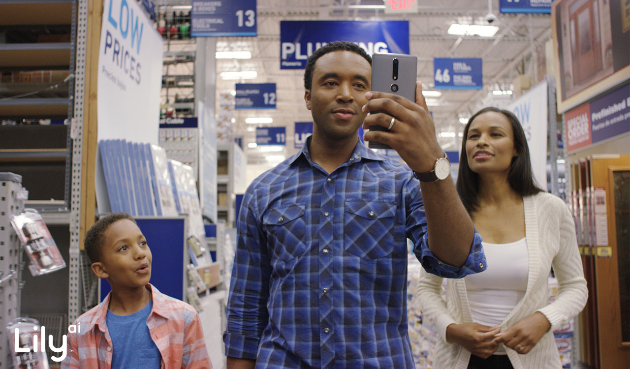 man holding phone in lowes using Retail AI tool