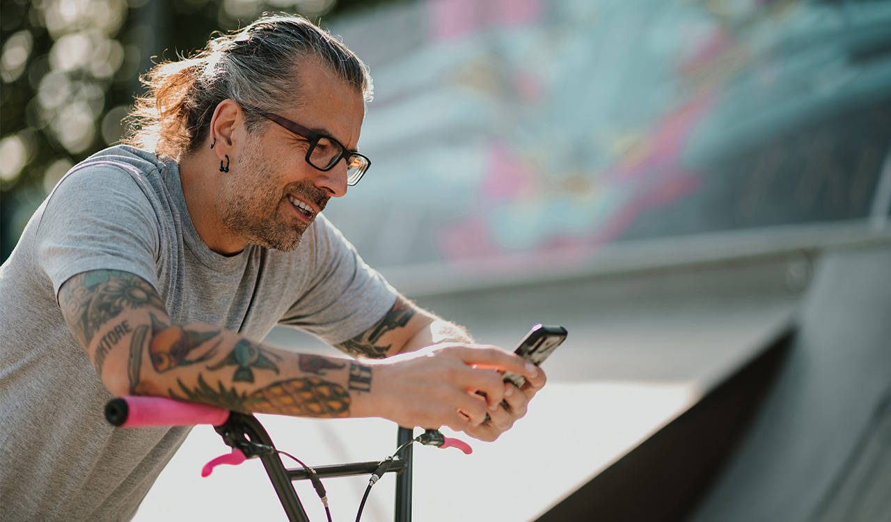 Gen X on bike looking at phone